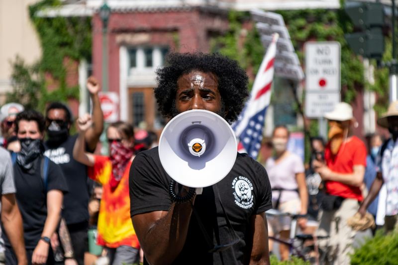 Campaigner speaking through a megaphone at a demonstration